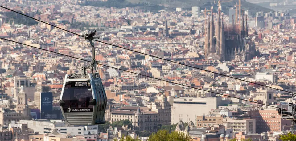88a977a6-fca1-4c1a-bb99-4e0cad5a7b06-montjuic-cable-car-barcelona-hanging-cables-climbing-buildings-city-sagrada-familia-church-its-32248779.jpg